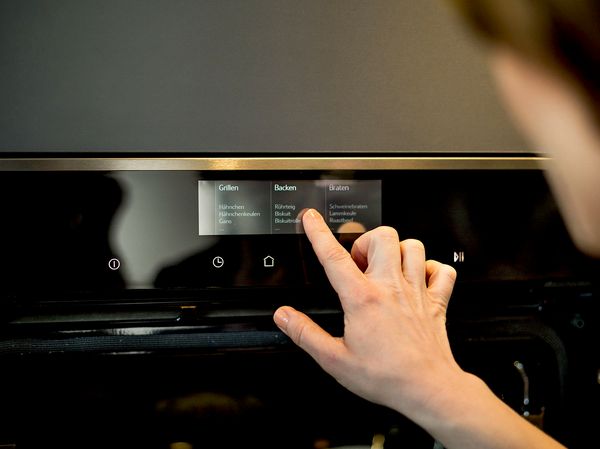 Person using NEFF oven control panel