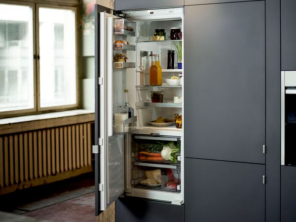 NEFF Fridge with door open in blue kitchen unit