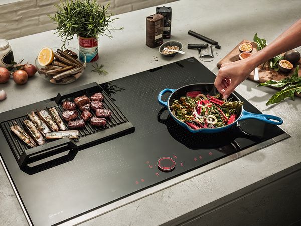 Food being cooked on NEFF hob TwistPad Fire function