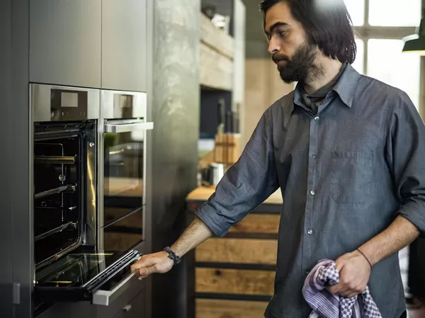 Man holding an oven door