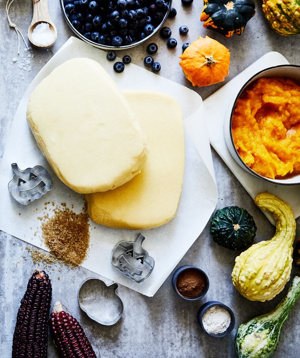 Numerous individual ingredients for halloween pumpkin pasties on counter top