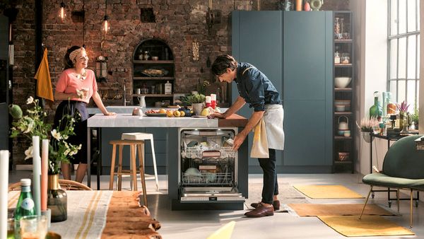 Couple using appliances in spacious open kitchen