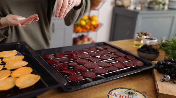 Beetroot and sweet potato slices on baking tray.
