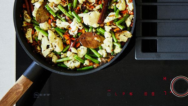 Pan frying vegetables on an induction hob