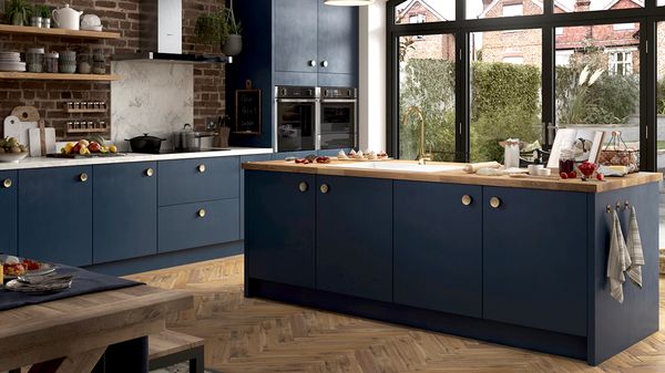 Brick and blue styled kitchen with NEFF N 50 built-in appliances