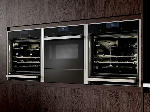 Three NEFF Ovens side-by-side housed in oak cabinets