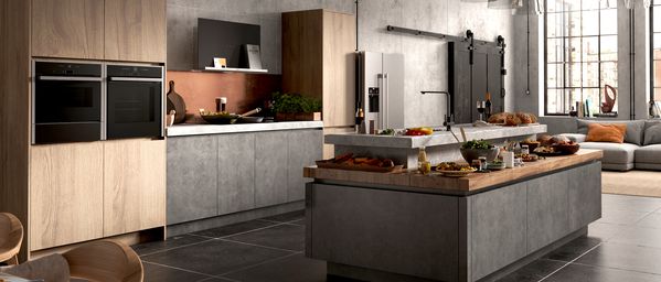 Wood and slate styled kitchen featuring NEFF N 70 Ovens