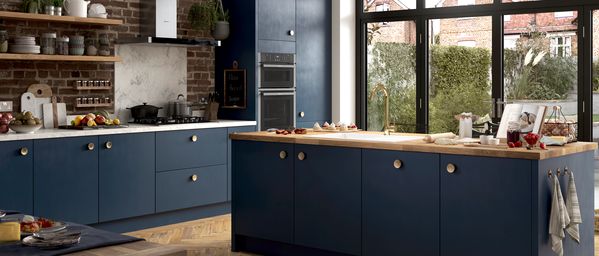 Brick and blue styled kitchen featuring NEFF N 50 Ovens