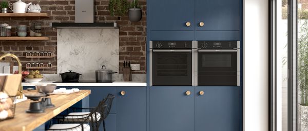 NEFF N 50 oven and hob in brick kitchen with blue cupboards
