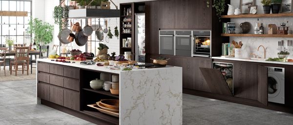 Oak and marble styled kitchen featuring NEFF N 90 built-in appliances doors open