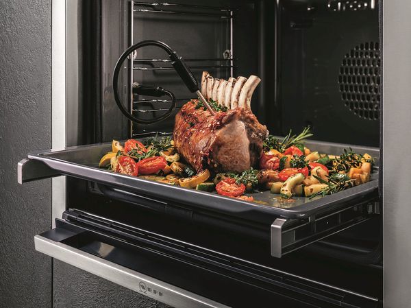 Rack of lamb roasting in NEFF Slide&Hide oven with veg