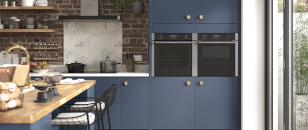 Brick and blue themed kitchen featuring NEFF N 50 built-in cooking appliances
